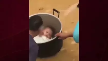 Çin'de sel sularında mahsur kalan baba bebeğini tencereyle kurtardı